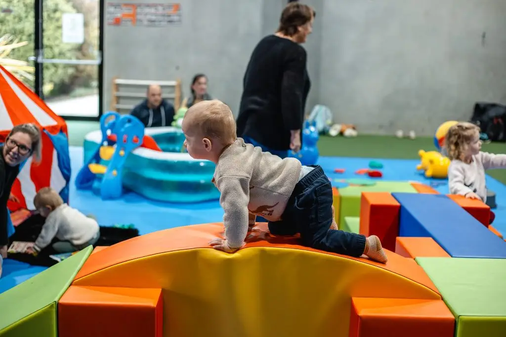 toddler climbing on climbing equipment at toddler sense Launceston.